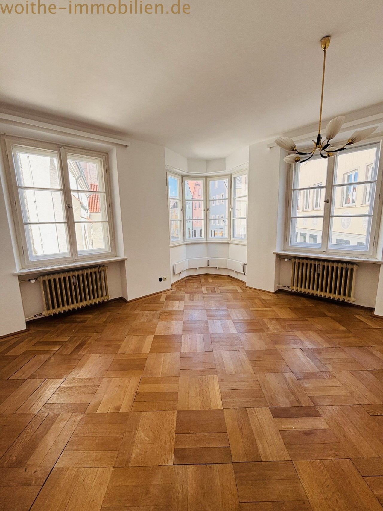 Bright living area with elegant open-plan design and high-quality parquet flooring Bright living area with elegant open-plan design and high-quality parquet flooring