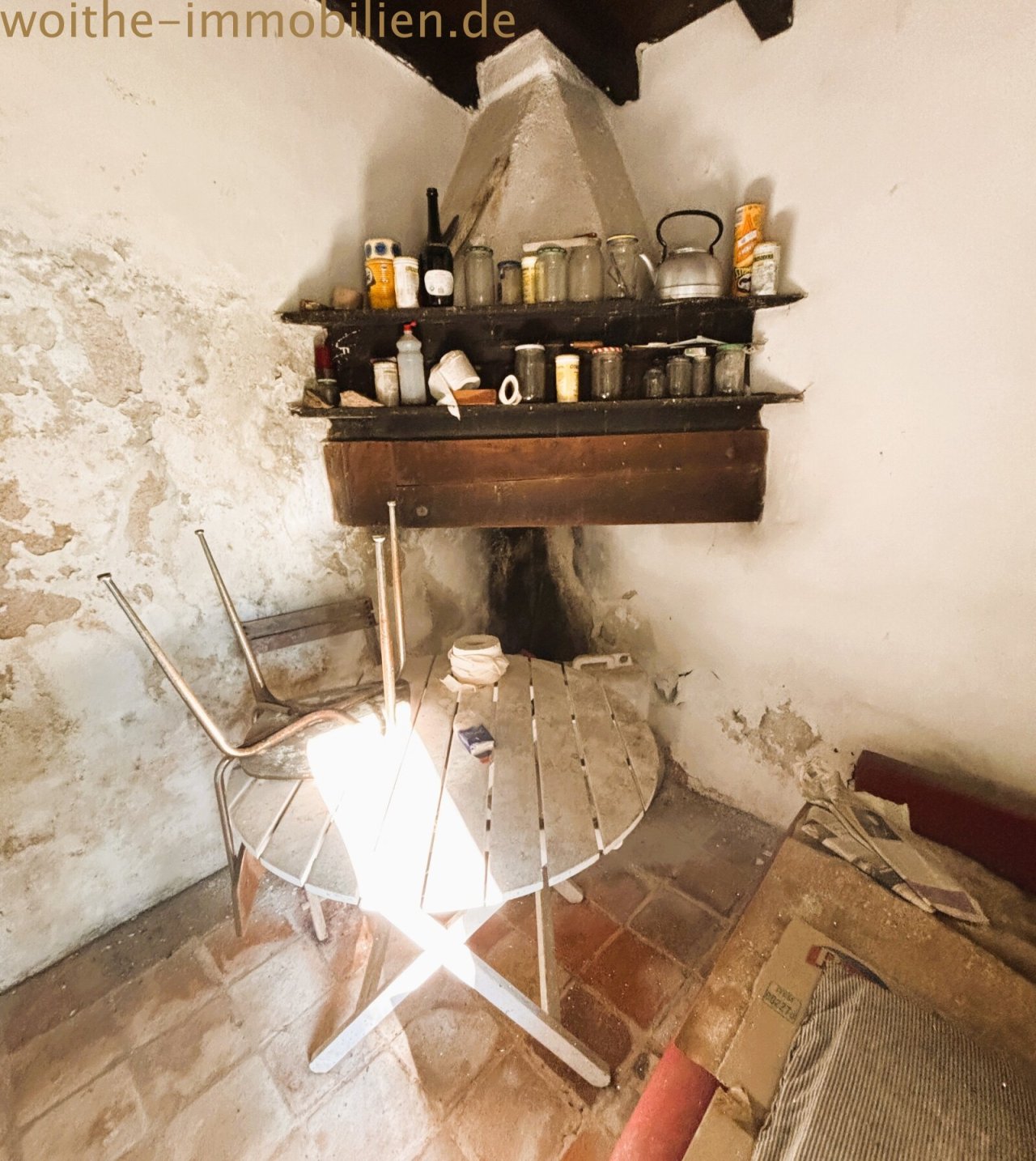 Cellar with rustic stone arch and built-in storage shelves Cellar with rustic stone arch and built-in storage shelves
