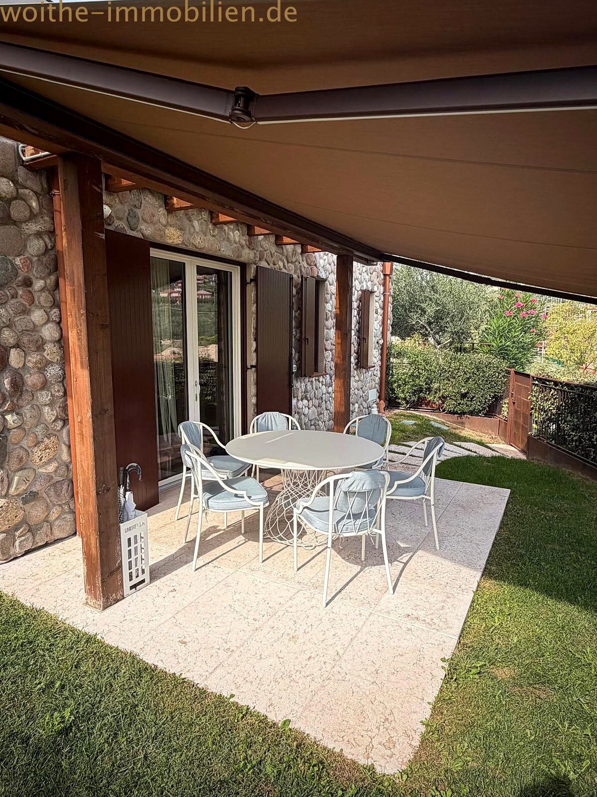 Covered terrace with natural stone walls – weather-protected outdoor area with direct garden access Covered terrace with natural stone walls – weather-protected outdoor area with direct garden access